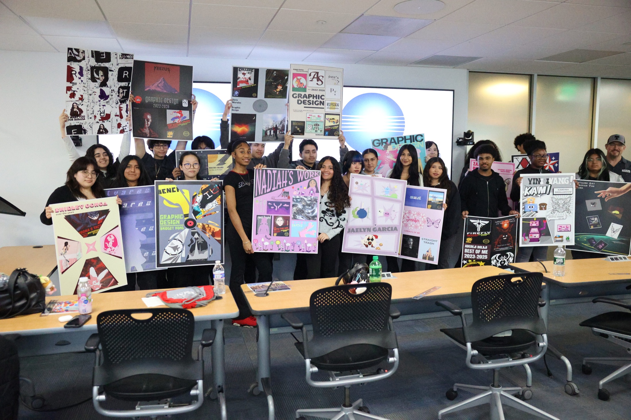 Students presenting finished design portfolio boards