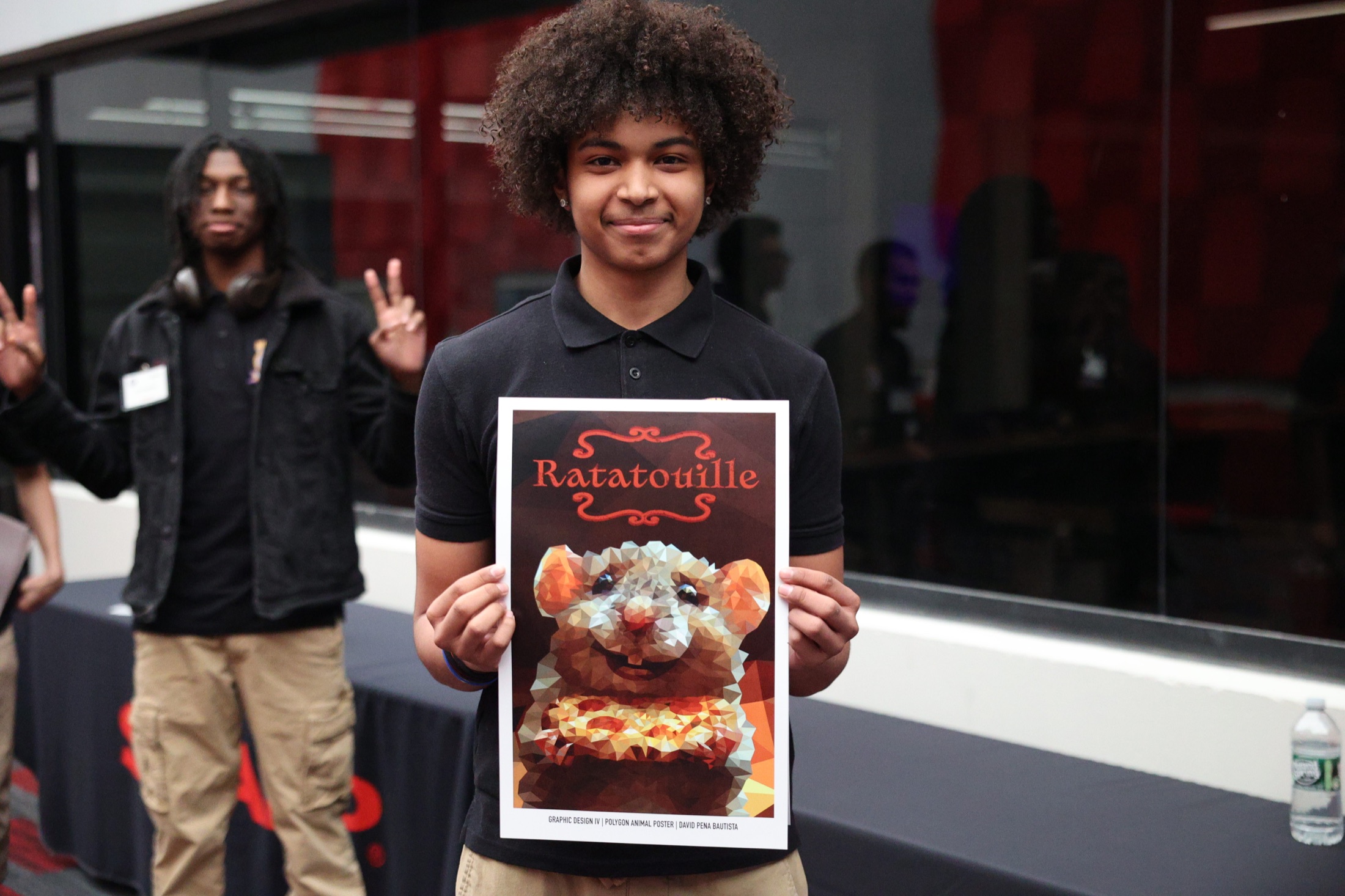 Student presenting a finished design poster